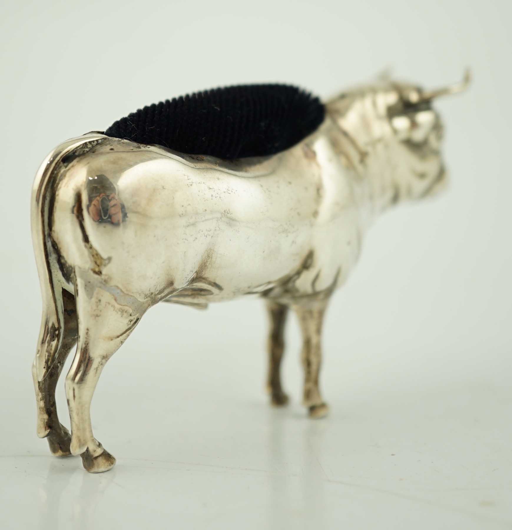 An Edwardian novelty silver pin cushion, modelled as a bull, Cohen & Charles